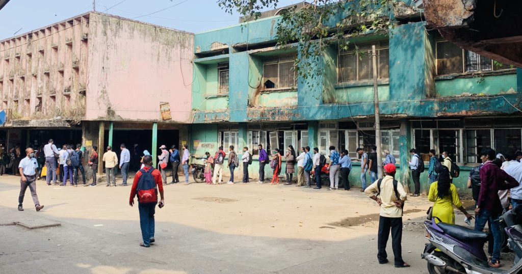 Commuters waiting in serpentine queue at Kalyan bus depot to begin their commute